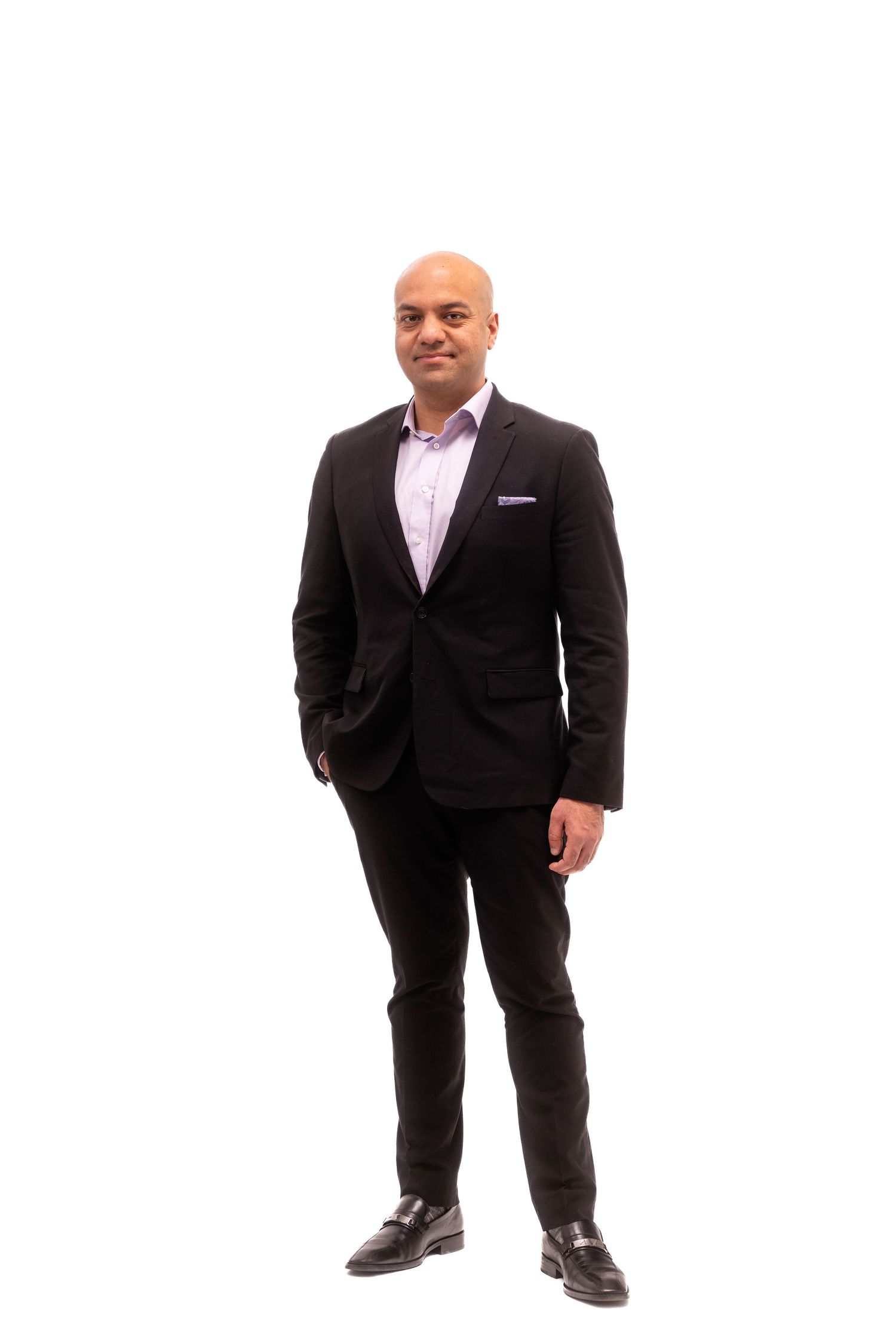 Person in black suit sitting in various poses on white background.