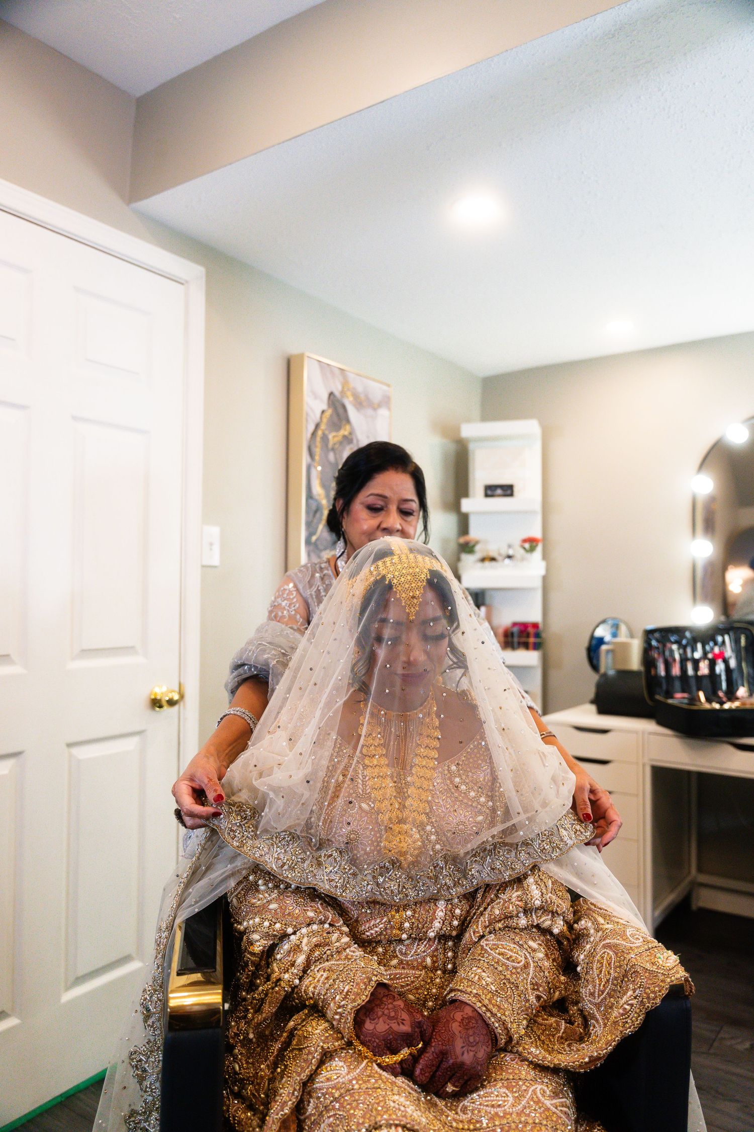 A person in a gold sequined dress and veil is shown in a series of getting ready photos in a dressing room.