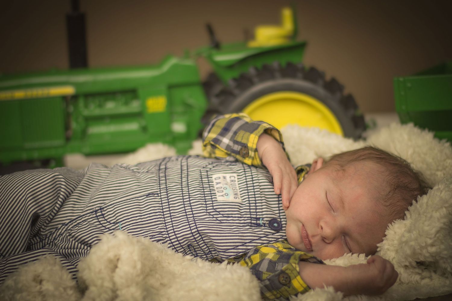Newborn boy with tractor