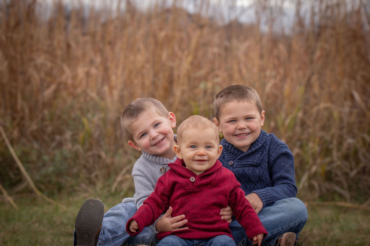 3 boys in a fall field