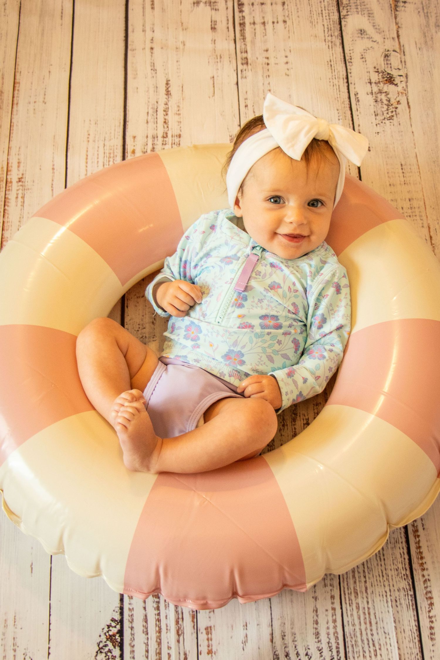 3 month old girl in pool float