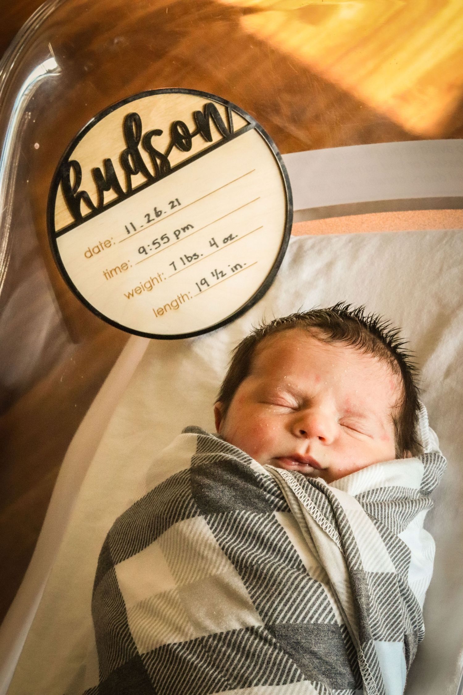 Newborn baby boy with name plaque