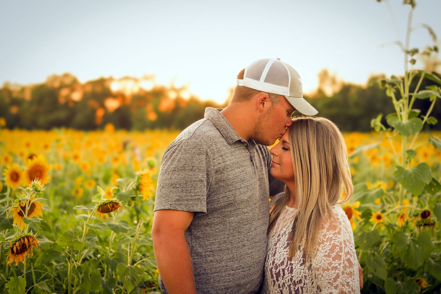 Couple kissing in sunflower field