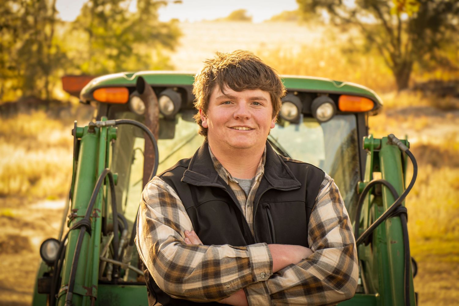 Senior boy by a John Deere tractor