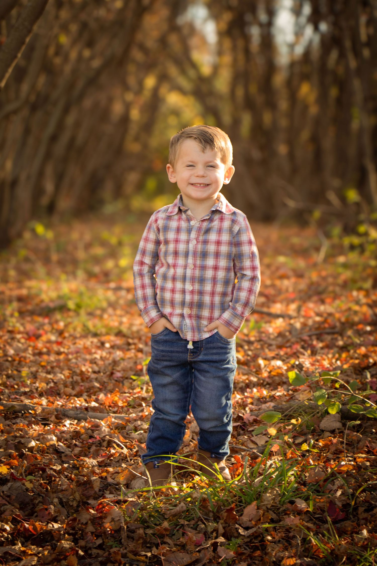 Toddler in the fall leaves