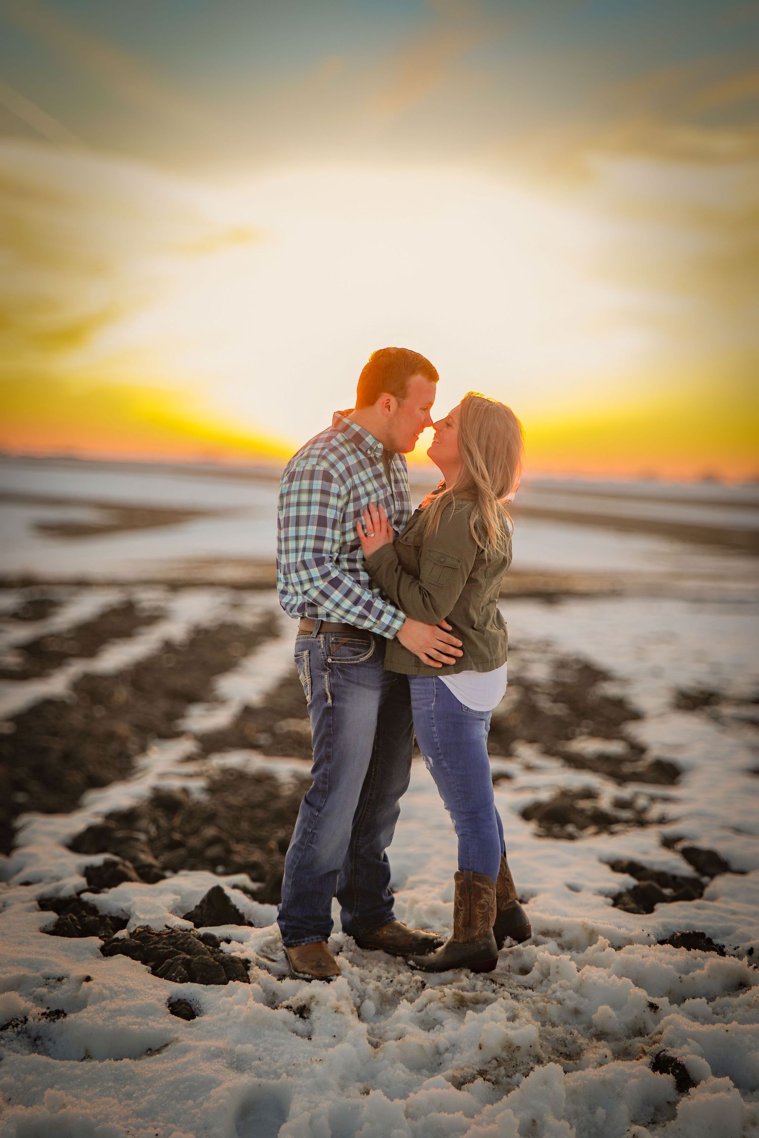Engaged couple at sunset in the snow