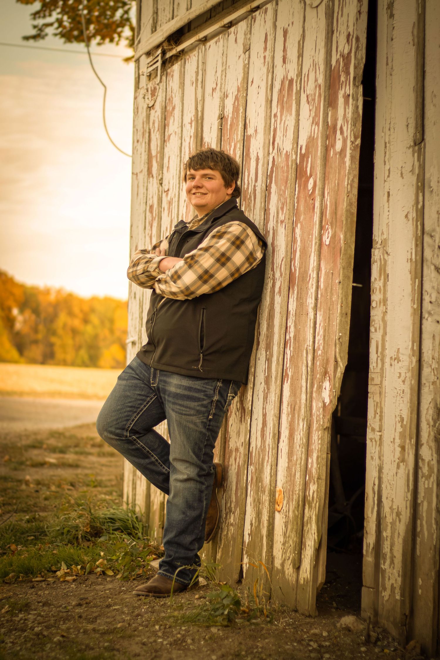Senior boy by a barn