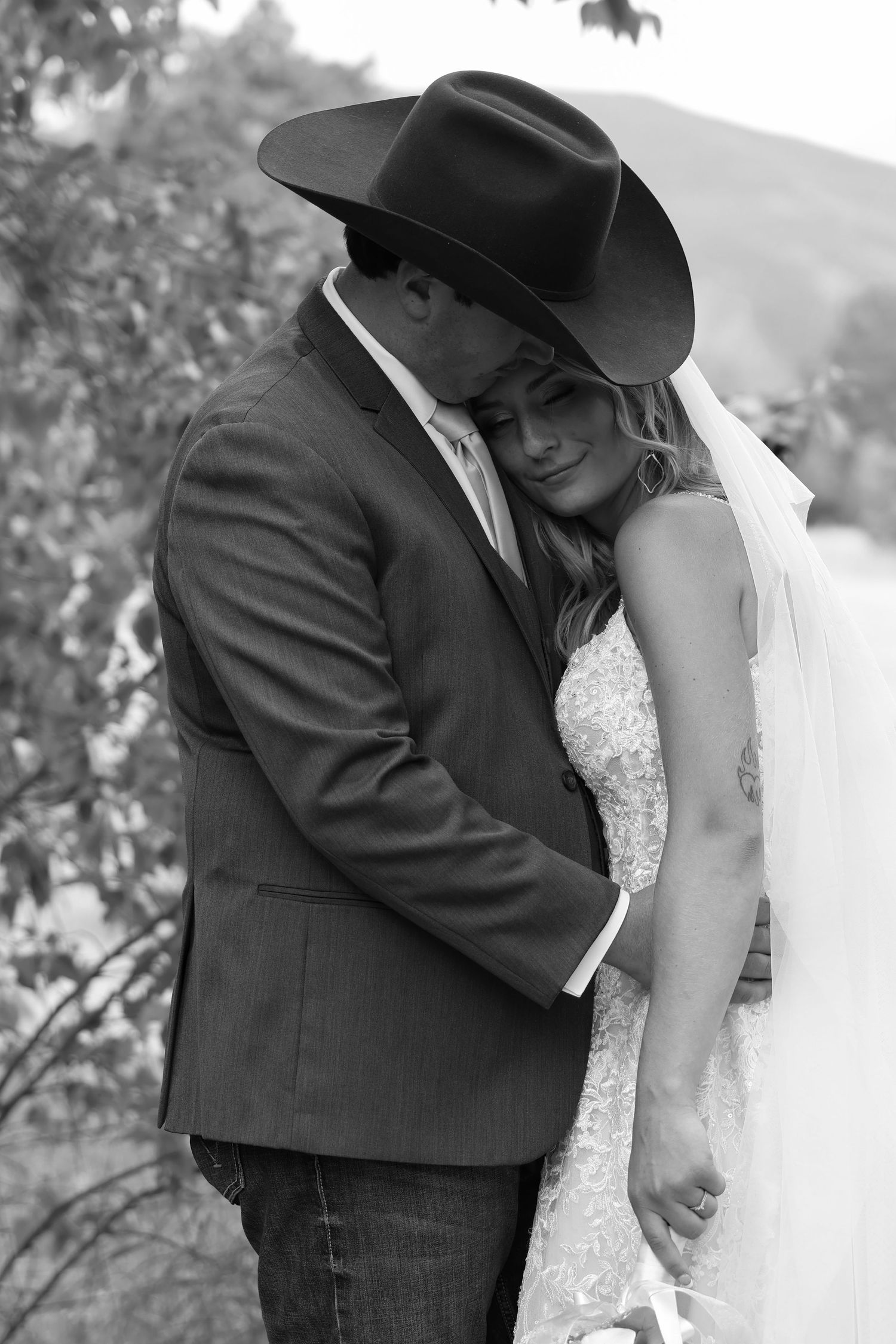 Romantic black and white wedding photograph of a couple sharing an intimate moment while at their Montana summer wedding.