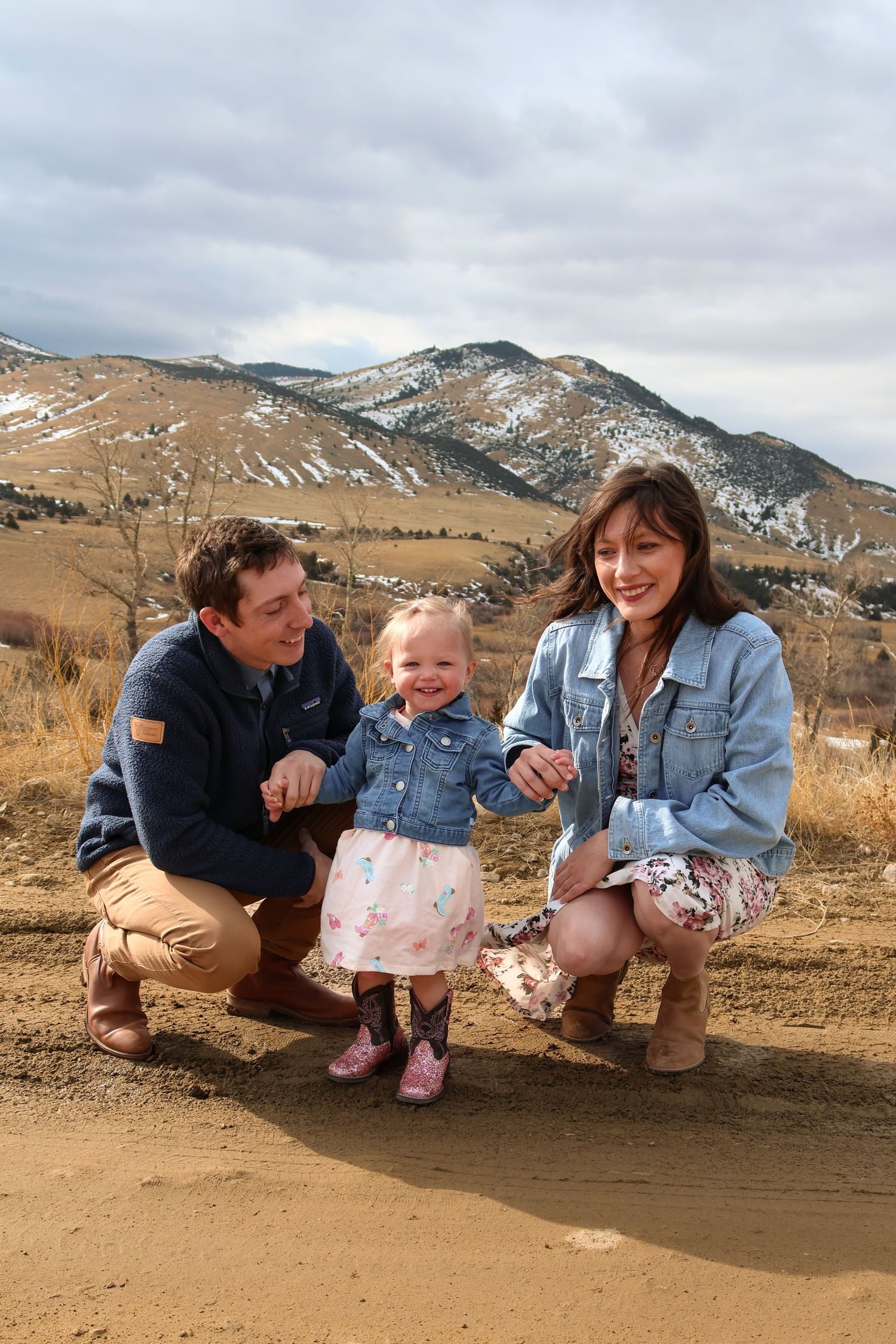 A sequence of four similar photos showing people crouching on a dirt path with snow-capped mountains in the background.
