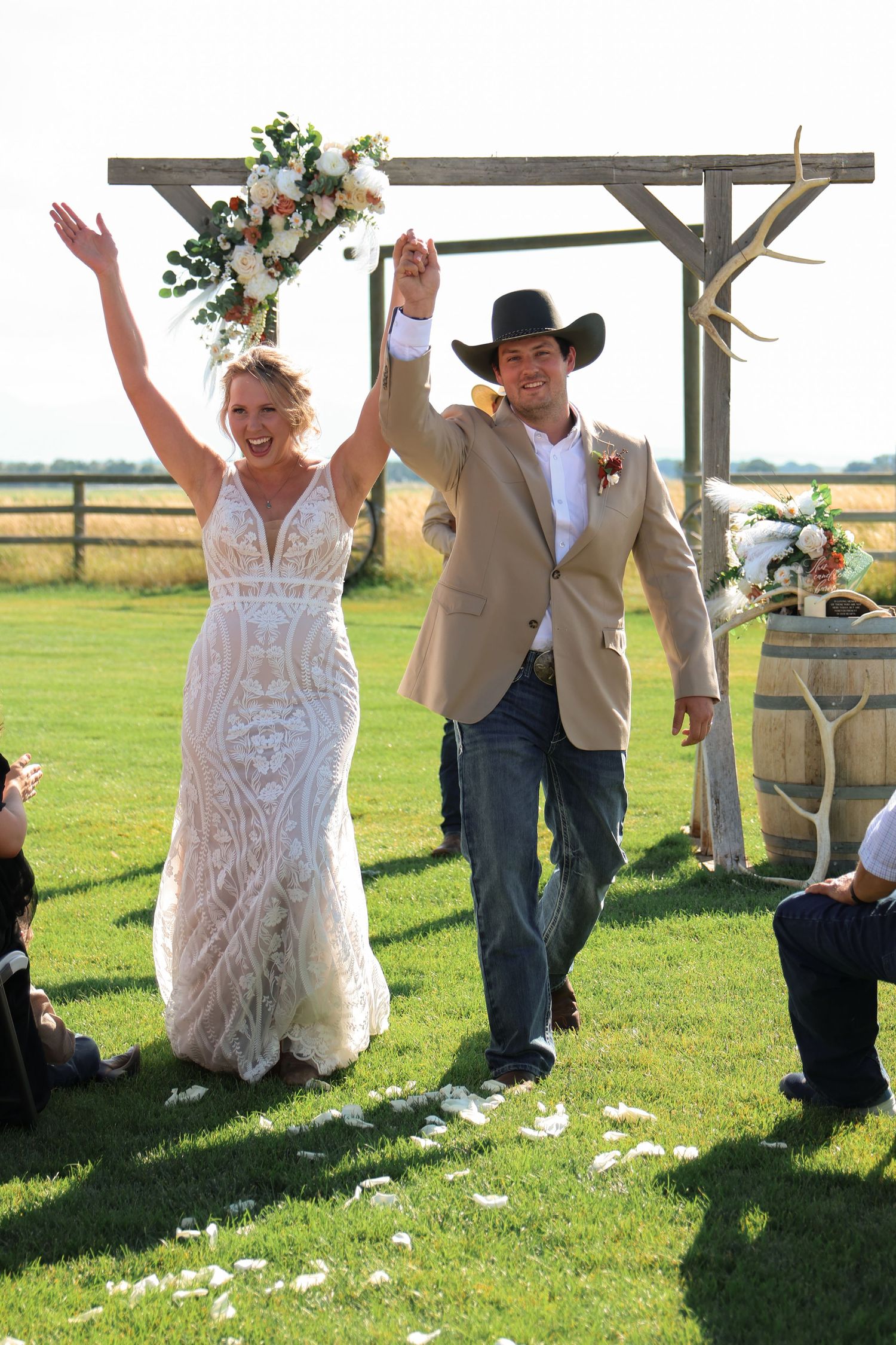 A sequence of wedding photos showing a bride and groom celebrating and jumping with joy in a sunlit outdoor field.
