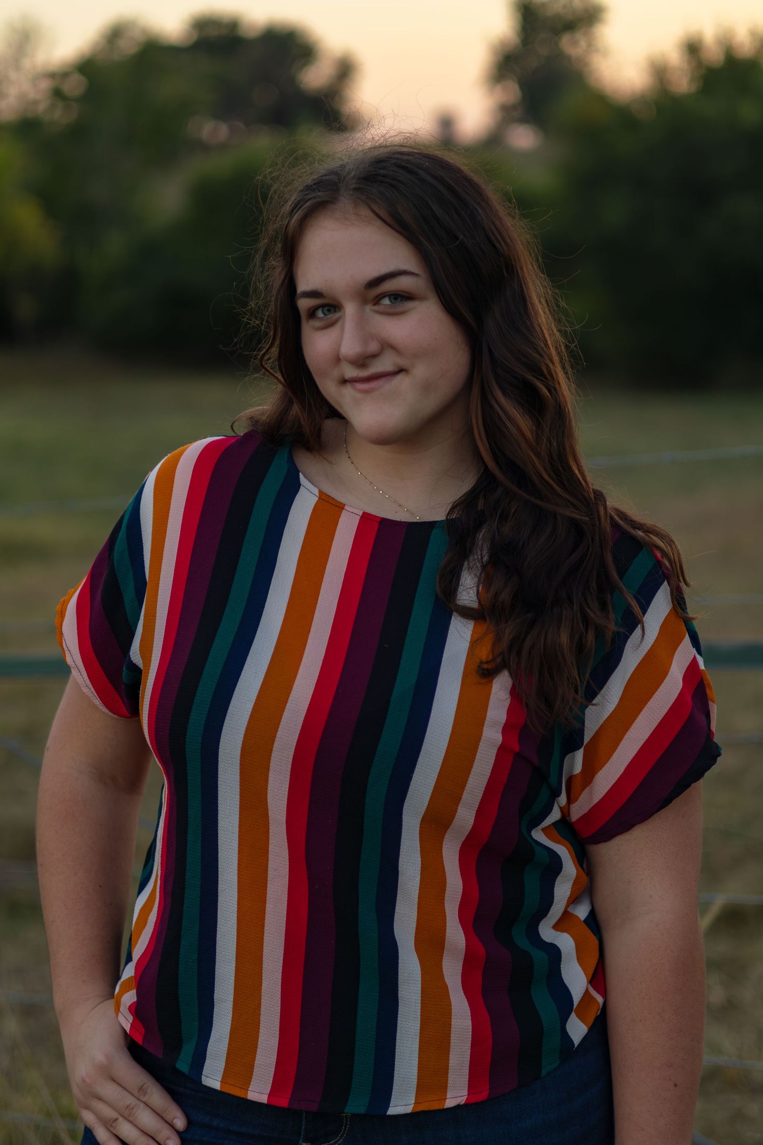 Multiple shots of someone in vibrant striped top during golden hour outdoor photoshoot.
