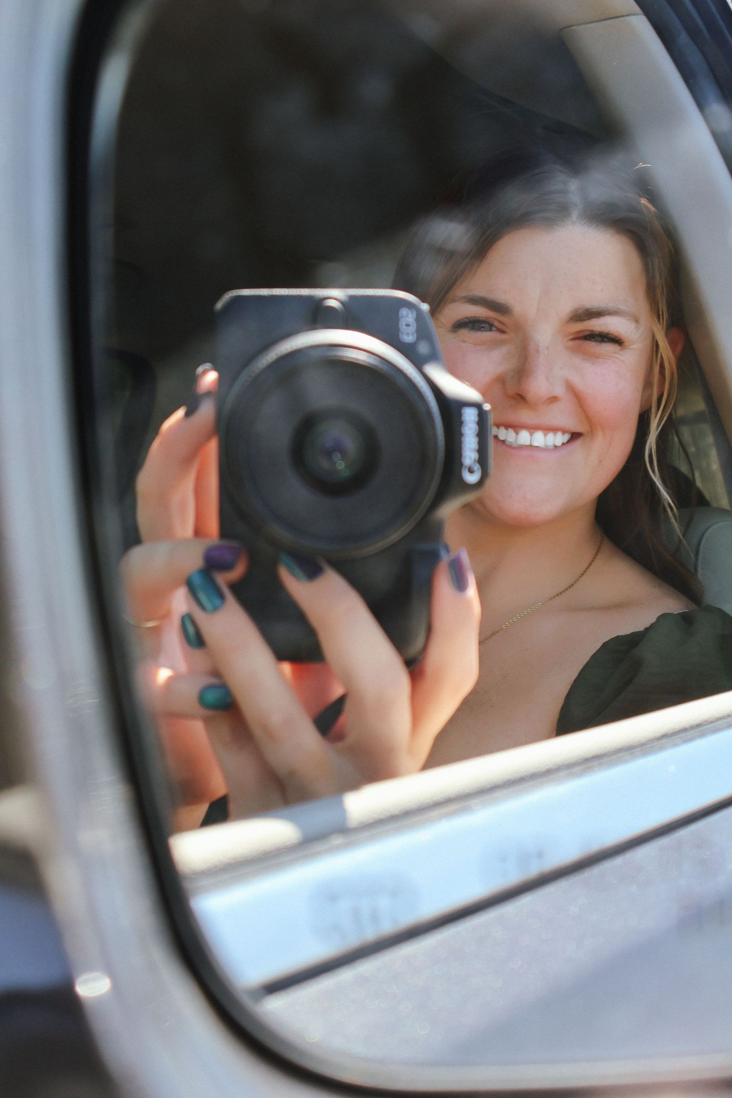 Series of car mirror selfies showing person holding black camera.