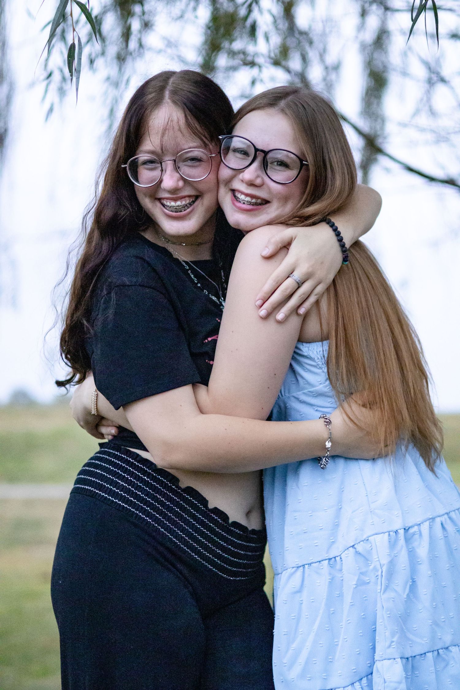 Two friends sharing joyful hugs and laughter in a series of candid outdoor photos.