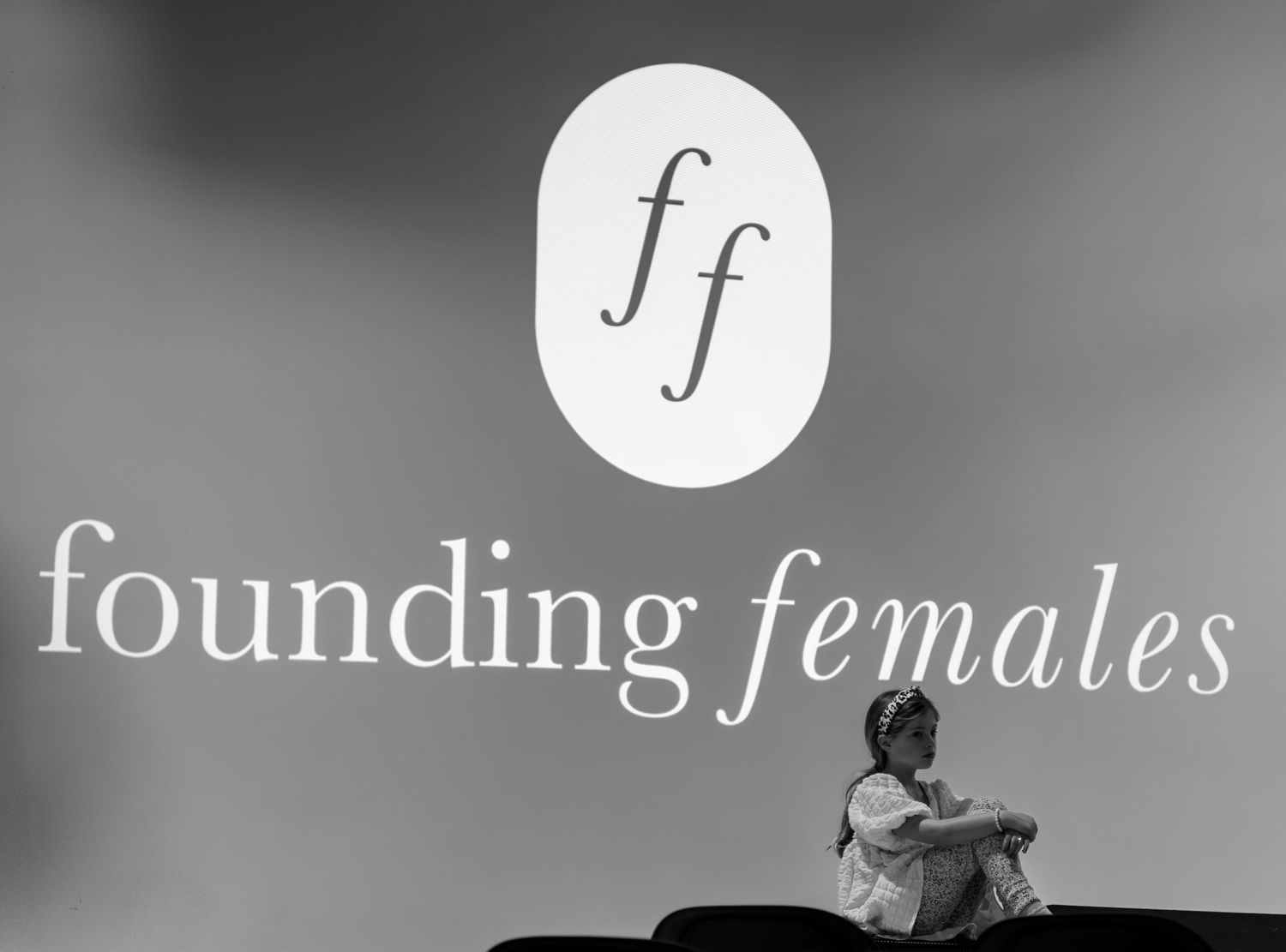 Stylized text design showing the word 'founding females' in elegant black and white typography with decorative elements.