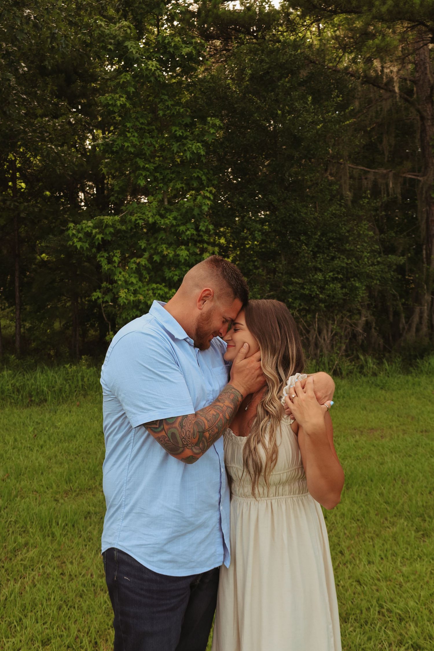 A couple shares an emotional embrace during their outdoor photo session.