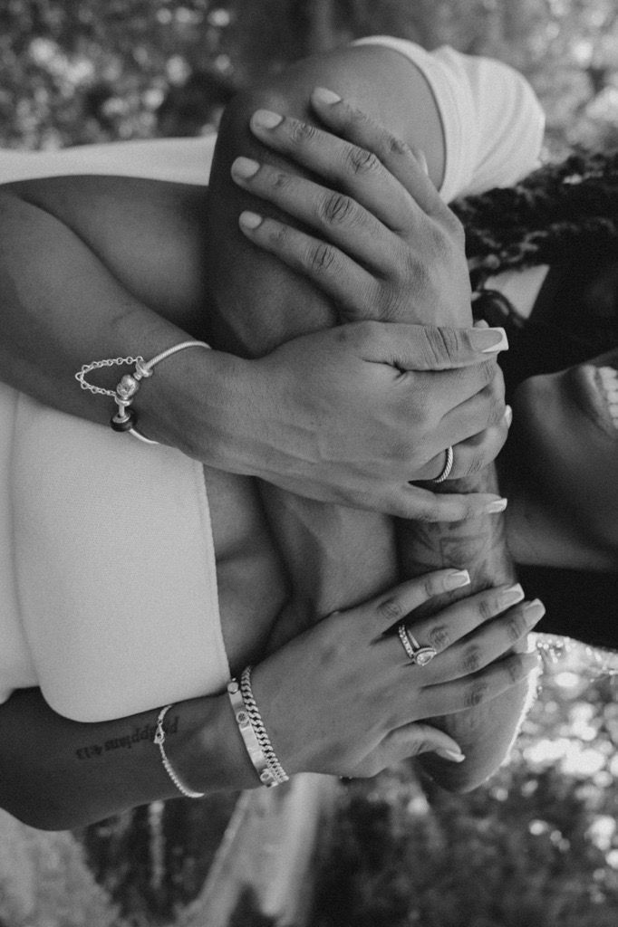 Black and white photo series showing close-up shots of hands with engagement and wedding rings.