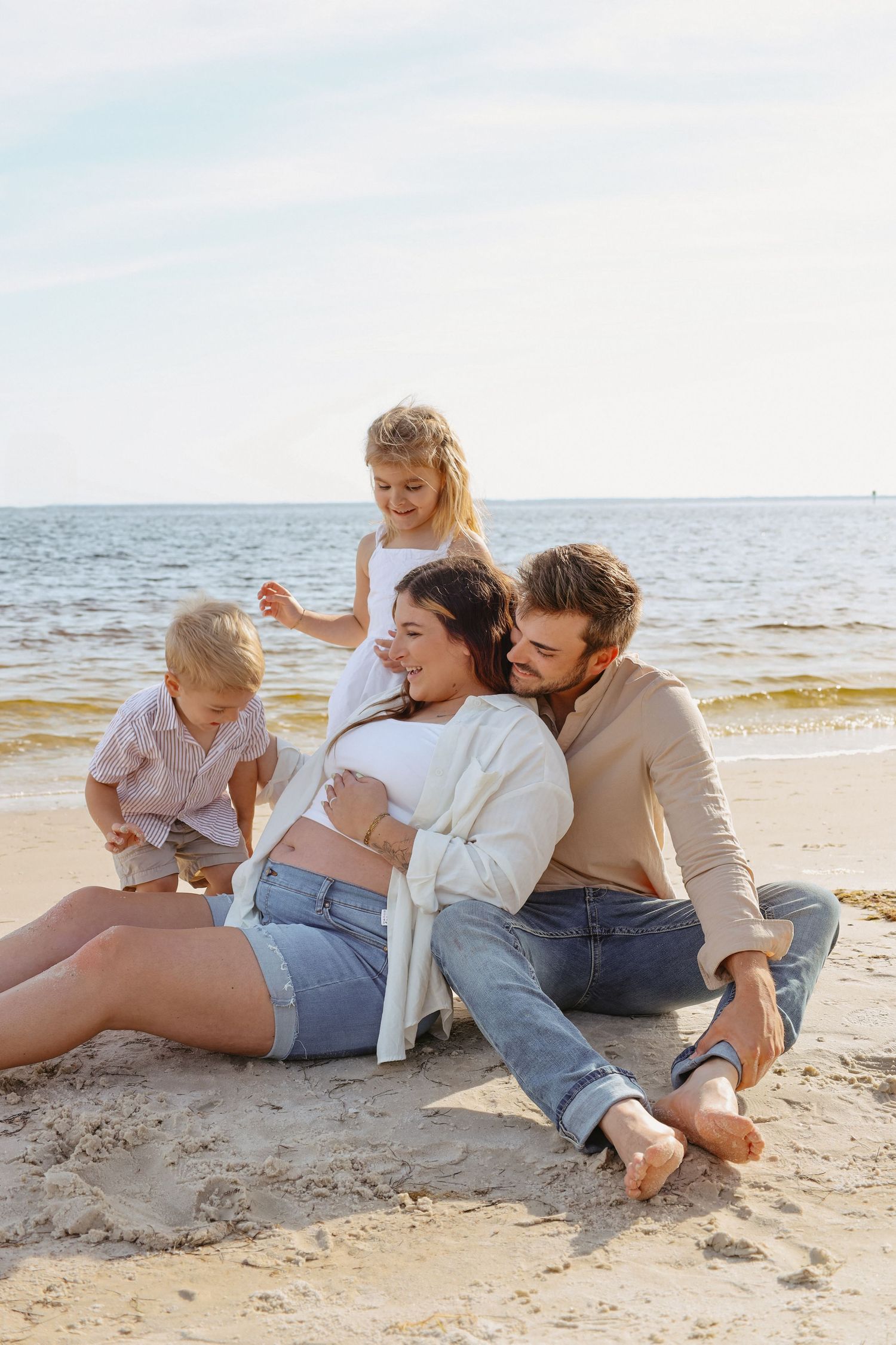 A relaxed group enjoying a casual moment together on the beach sand.