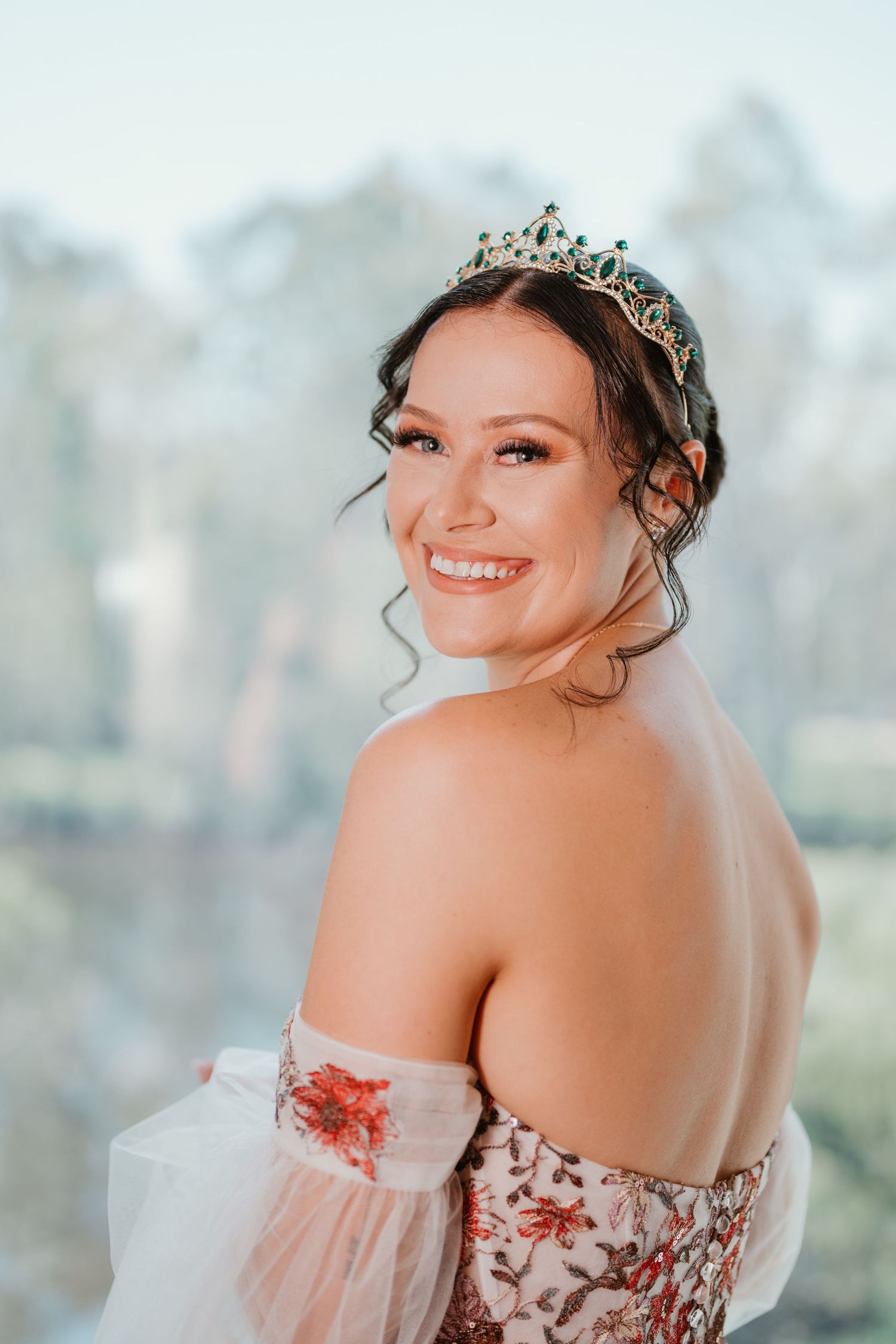 Bridal portrait showing off the back of a floral dress and delicate tiara.