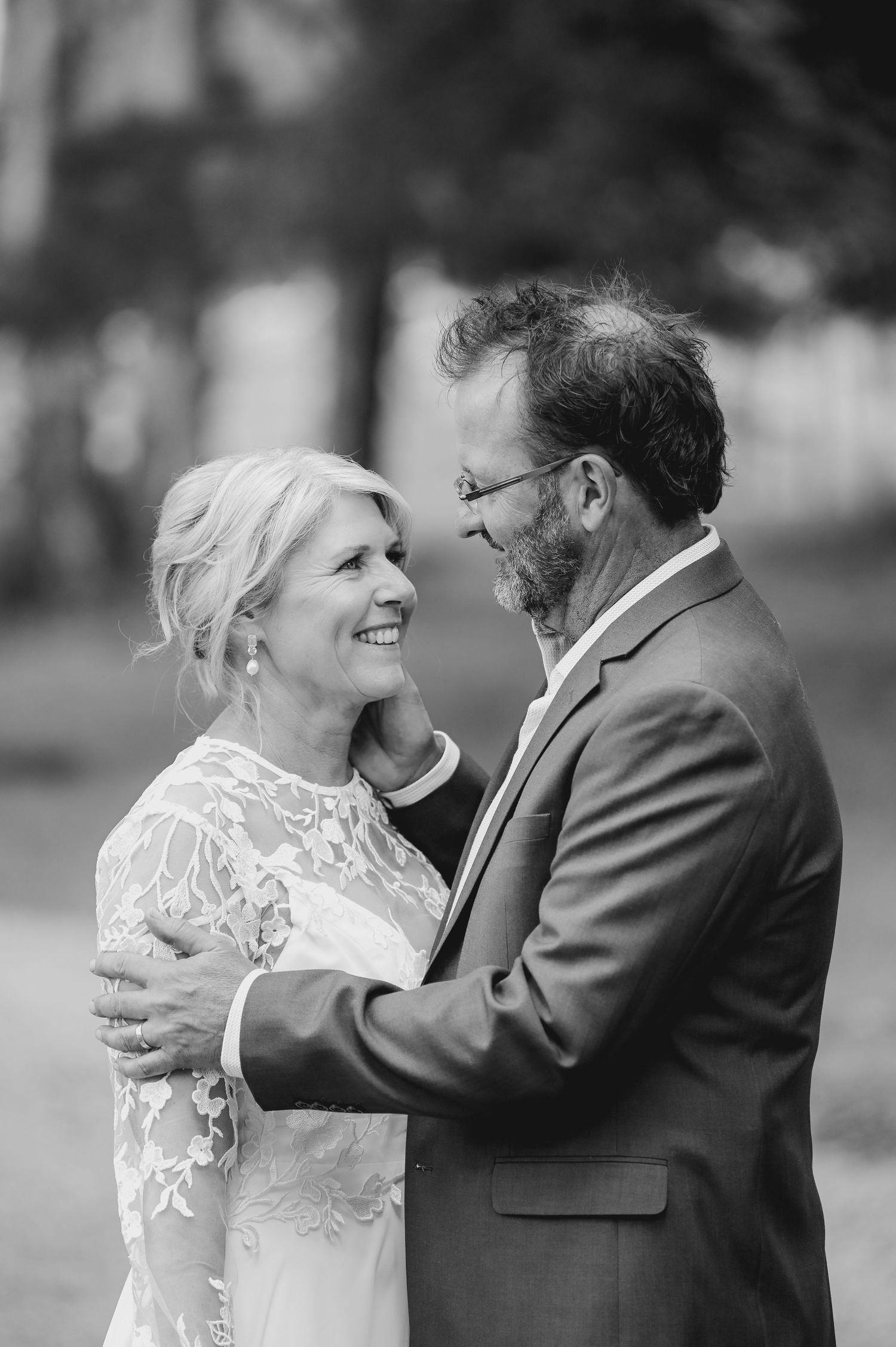 A romantic black and white wedding photo sequence showing a couple embracing and sharing joyful moments together.