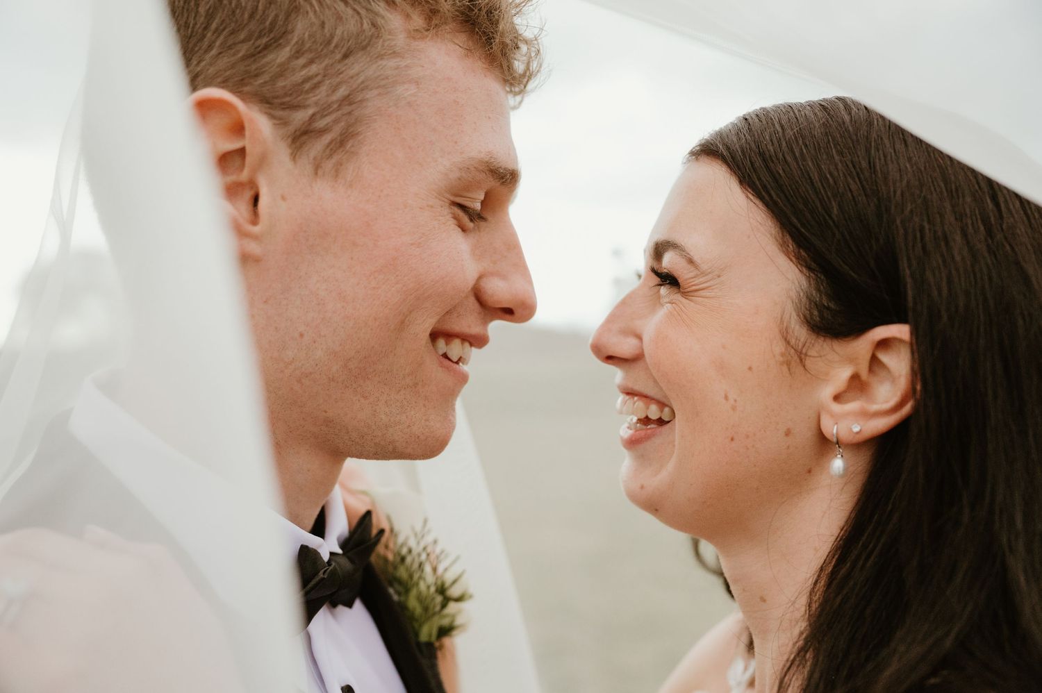 Close-up profile shots of happy newlyweds sharing tender moments against soft white background.