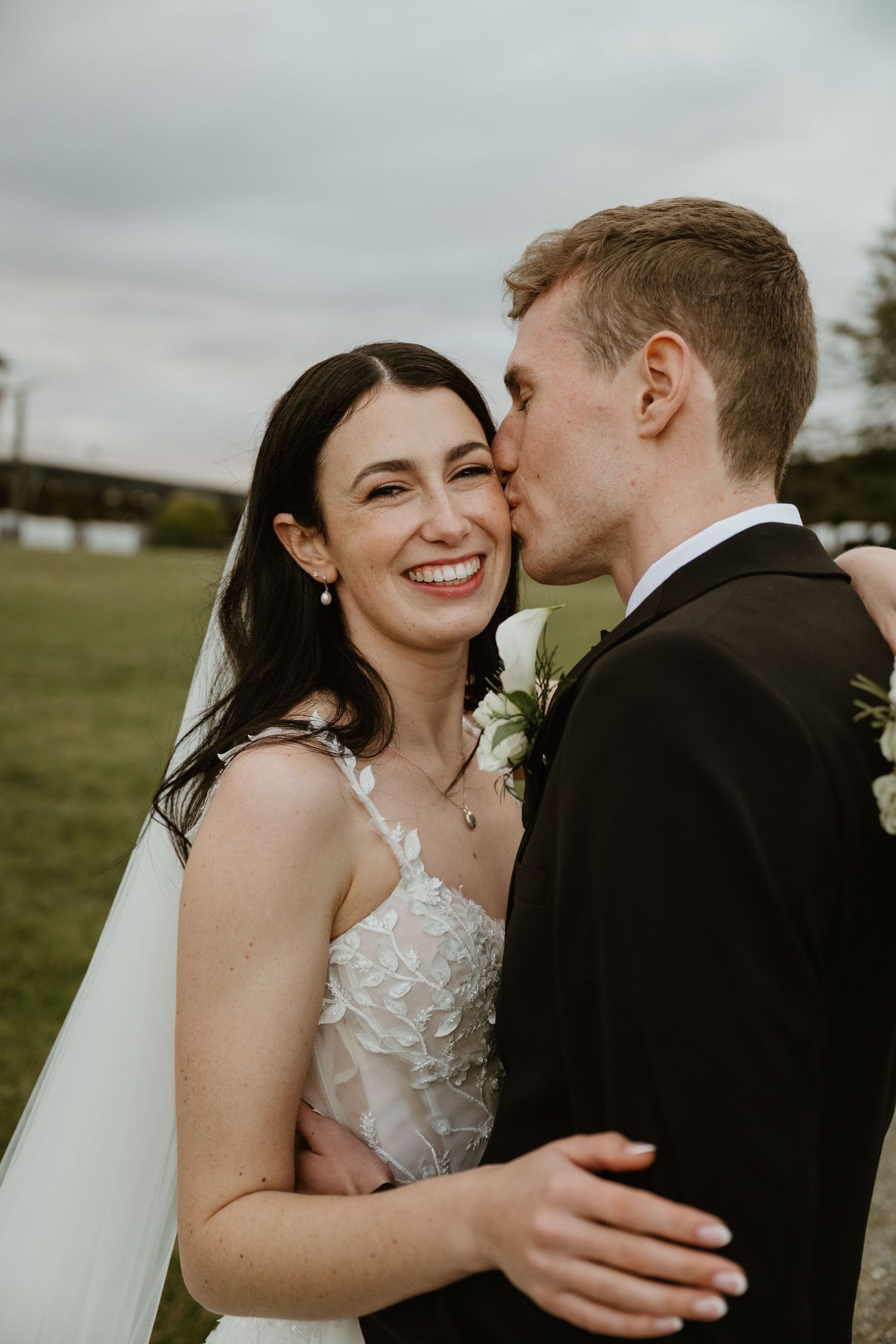 Intimate wedding photography sequence capturing romantic moments between newlyweds in natural outdoor setting.
