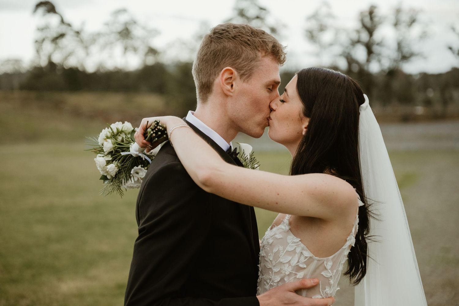 Romantic sequence of newlyweds sharing intimate moments in a rustic outdoor setting.