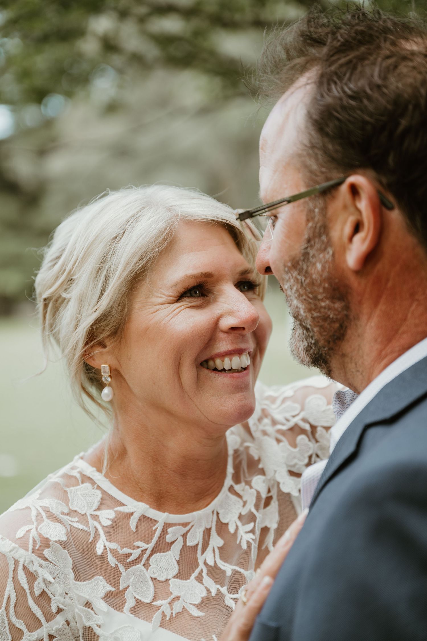 A couple shares intimate wedding moments in a series of candid photos showing joyful laughter and tender expressions.
