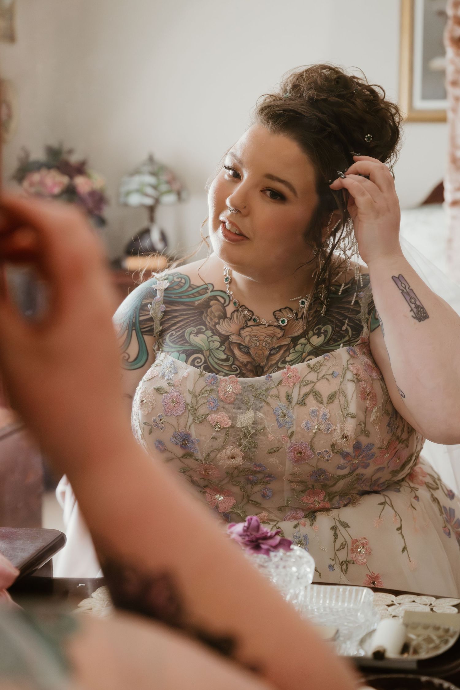 A series of photos showing someone getting ready in a floral patterned dress with soft lighting and romantic styling.