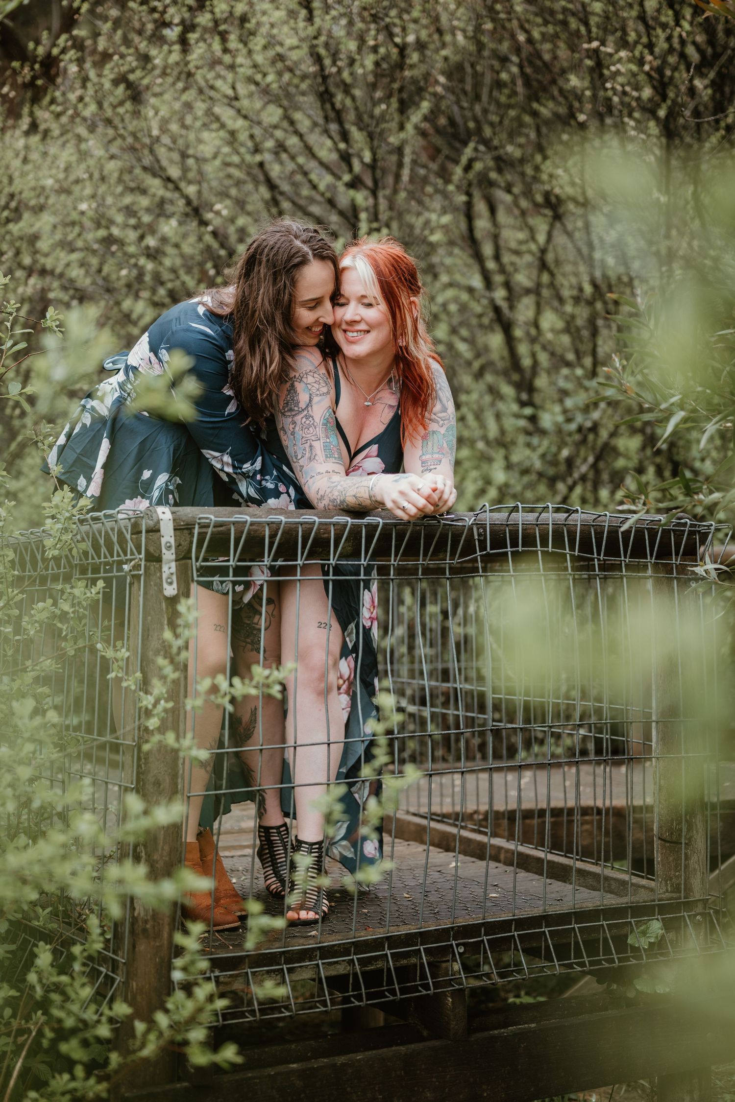 Playful moment captured on rustic bridge surrounded by lush greenery.