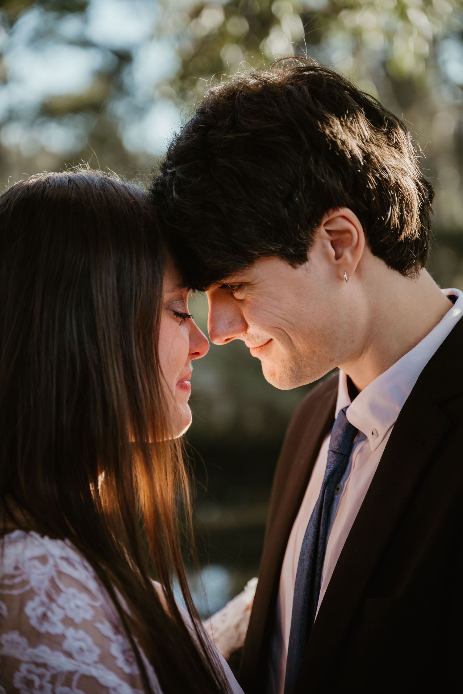 A romantic silhouette of a couple sharing an intimate moment in golden sunlight.
