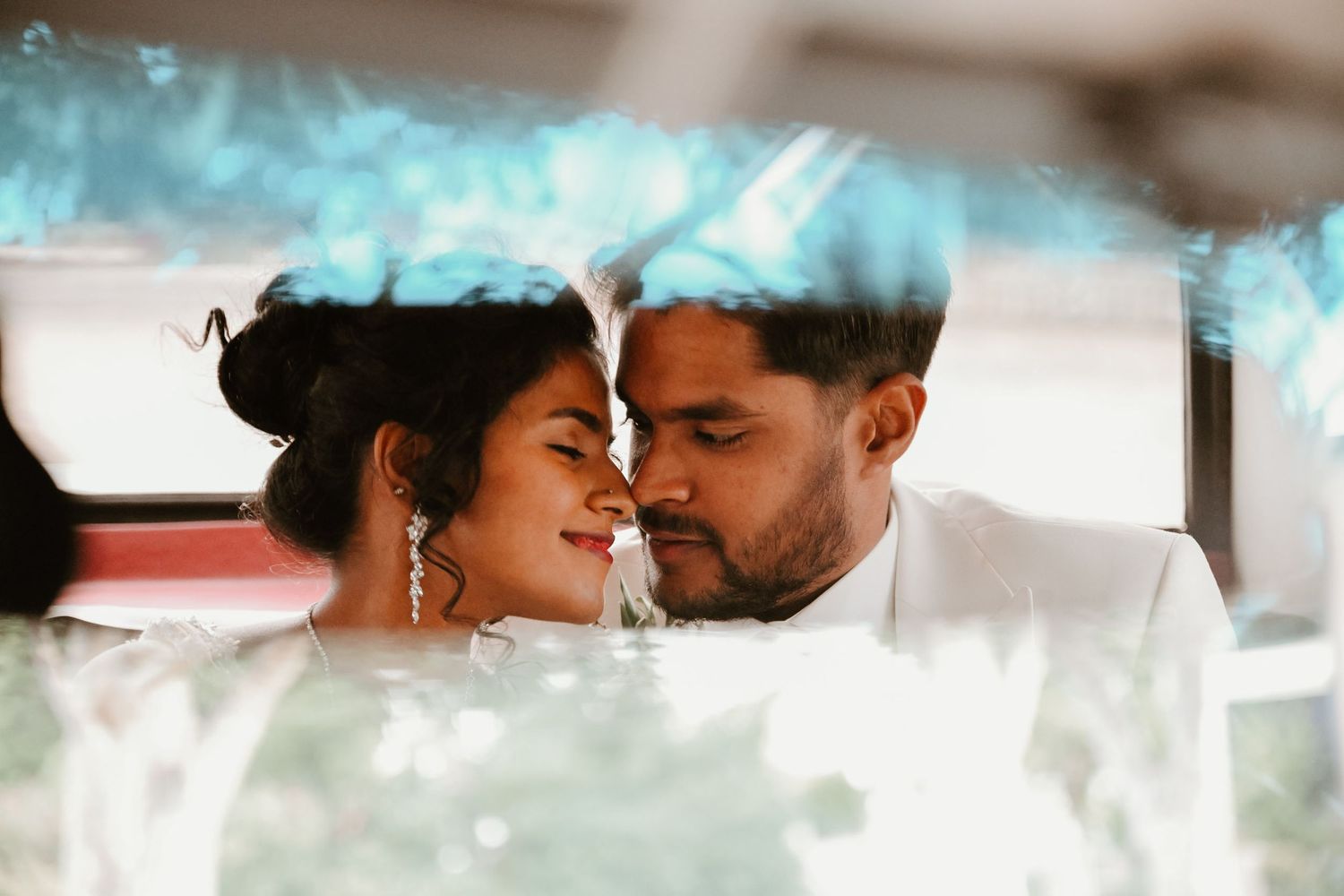 An intimate romantic moment captured between a couple during their wedding day.