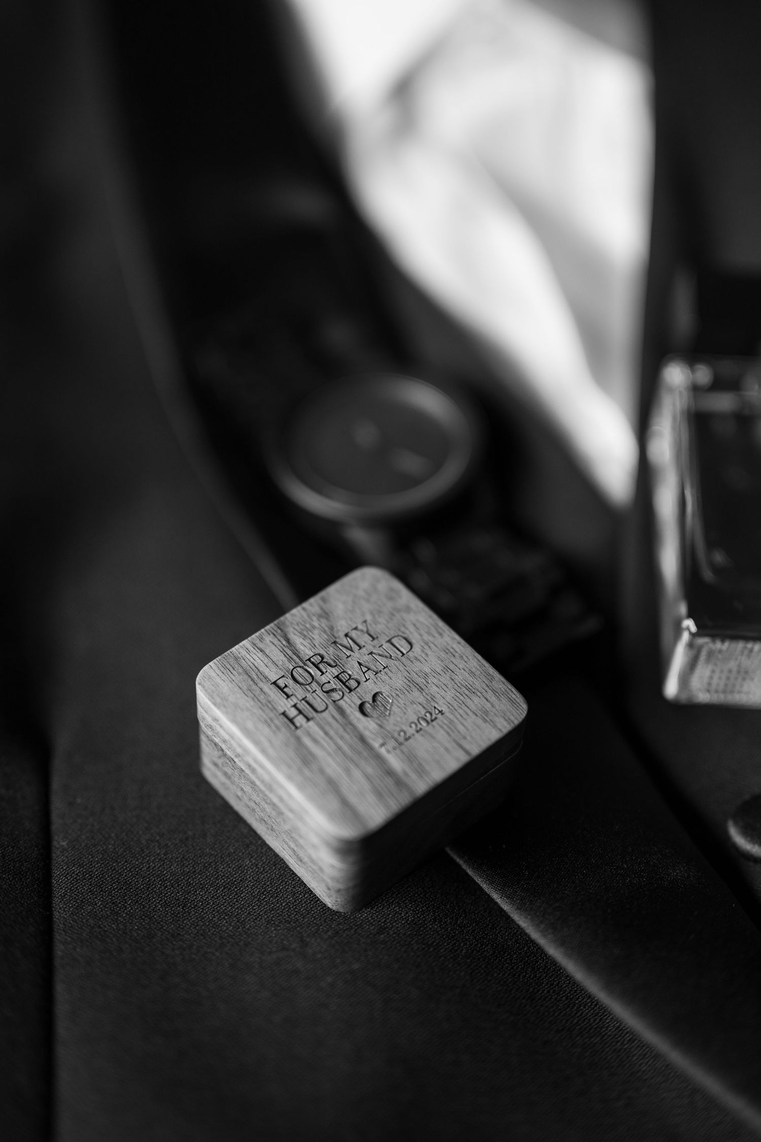 Black and white detail shot of a well-worn wooden box in shadow.