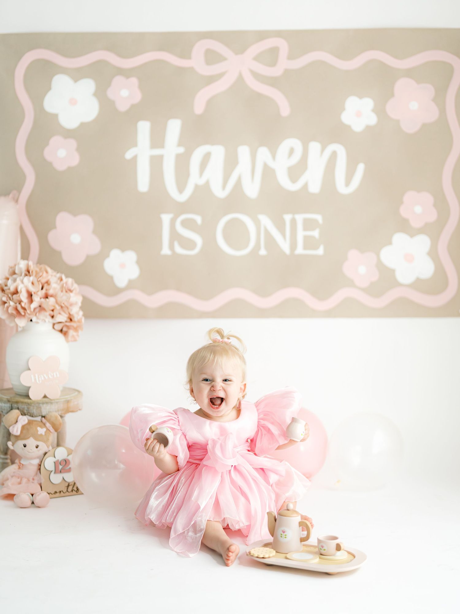 A collage of pink and beige birthday photos featuring a tutu dress, teddy bears, and floral decorations for a first birthday.