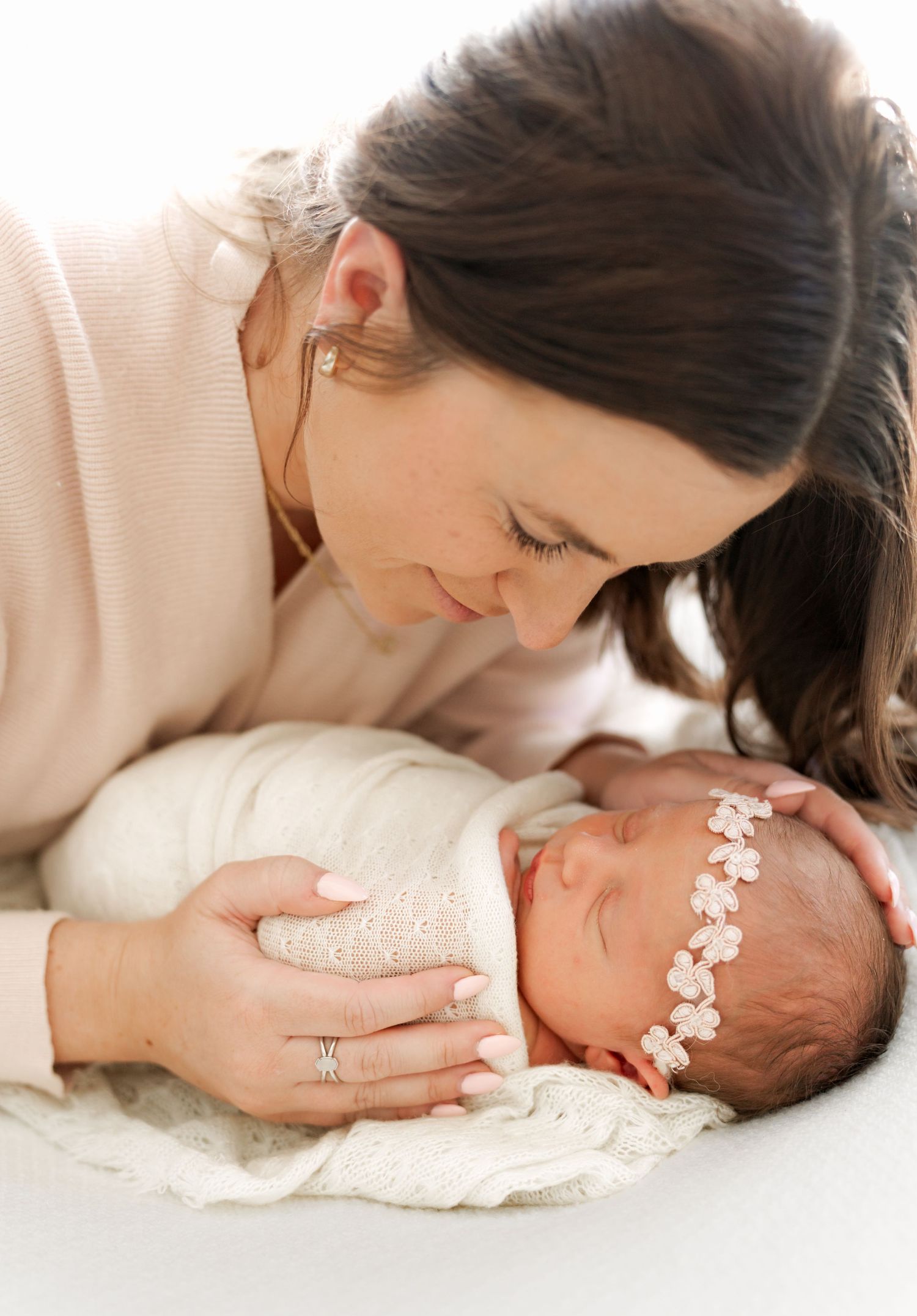 Artistic black and white newborn photography series with delicate lace details.