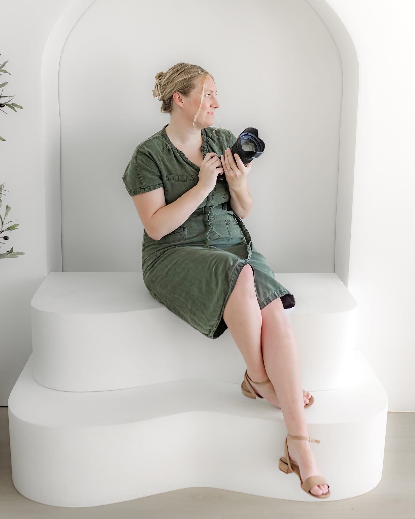 Creative portrait poses against white studio backdrop with green dress and minimalist styling.