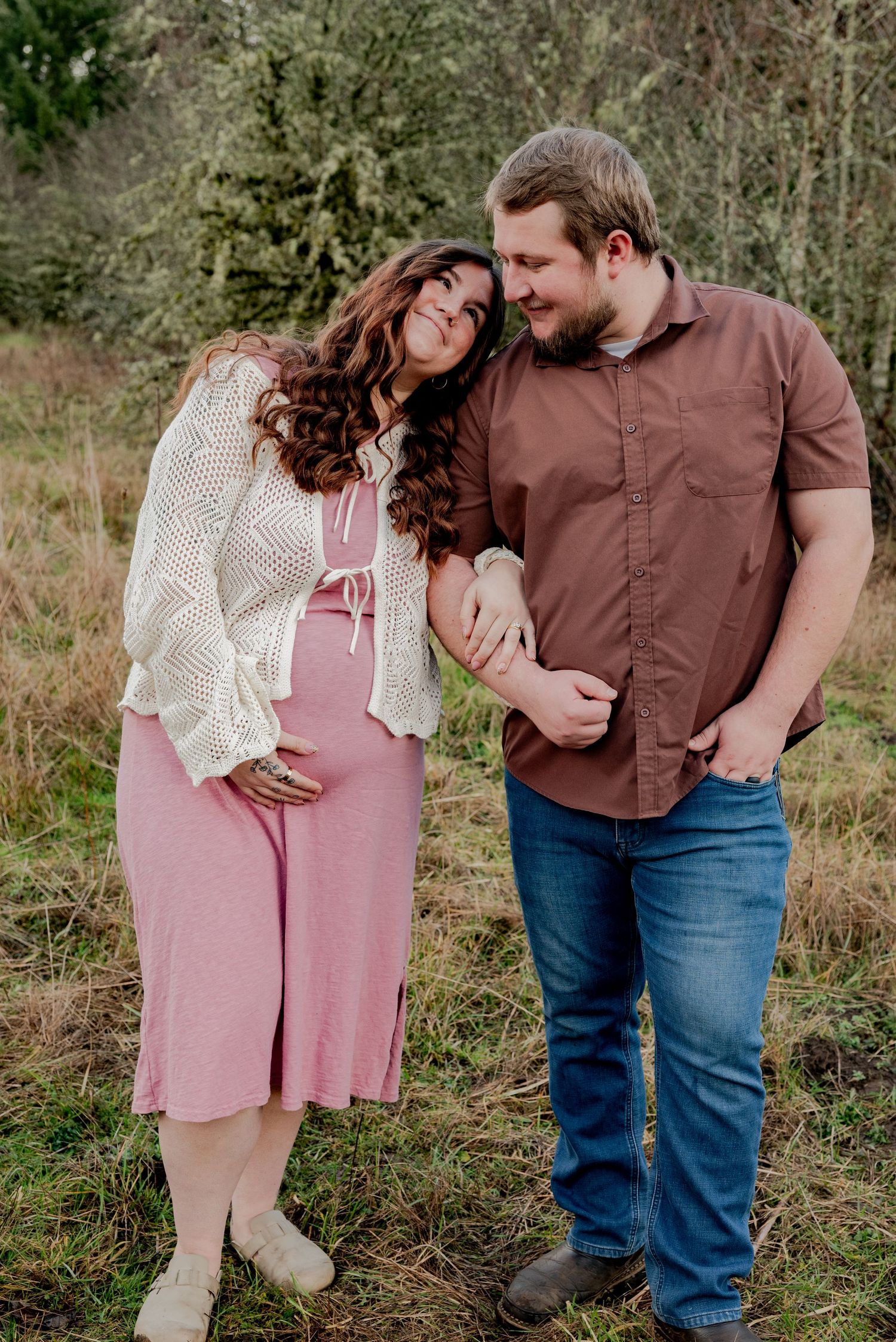 Olympia, Washington, A couple in pink and brown outfits share tender moments in a series of outdoor photos against a natural backdrop.