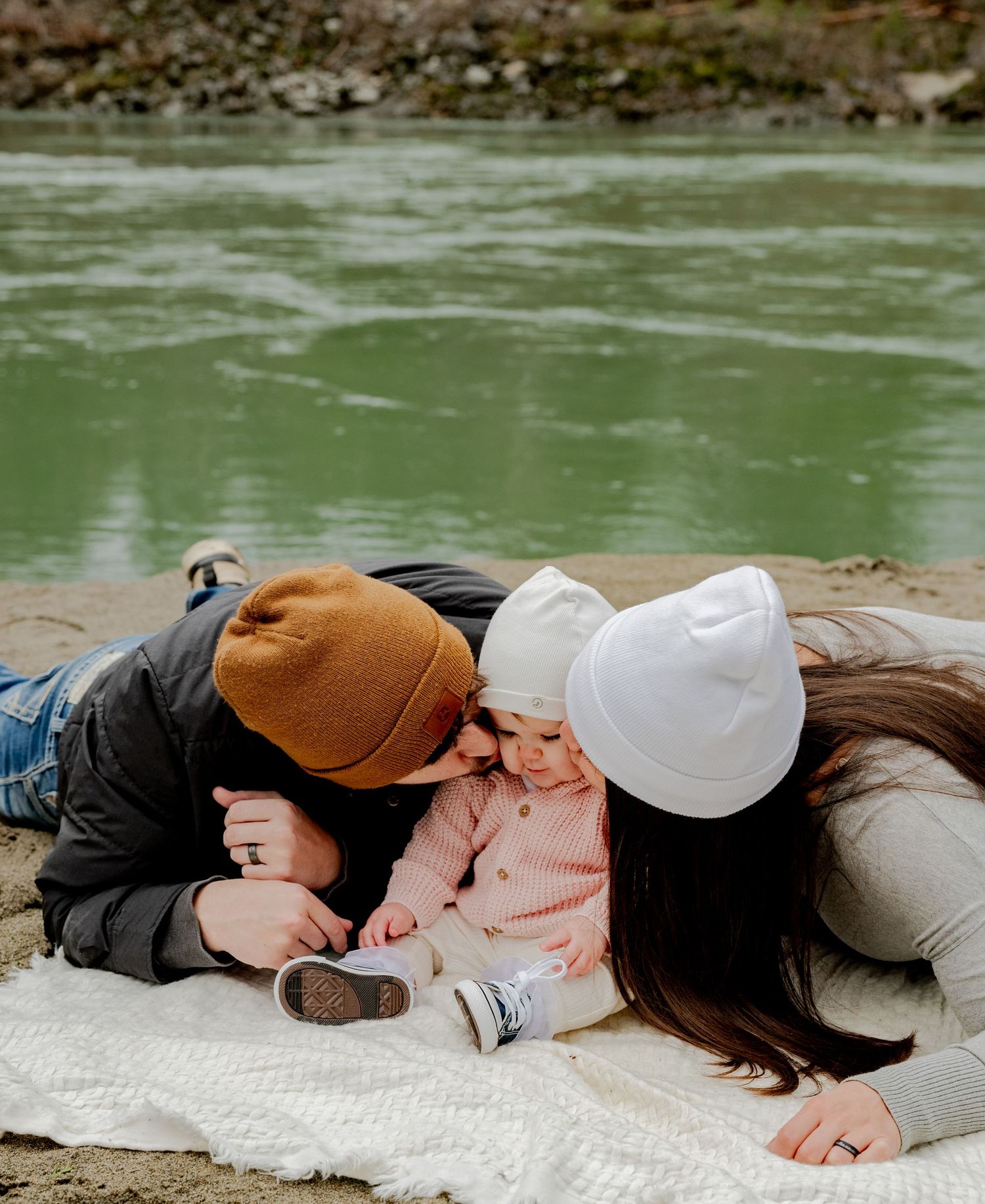 Gold Bar, Washington, Two people in casual attire lying close together on a white blanket outdoors.