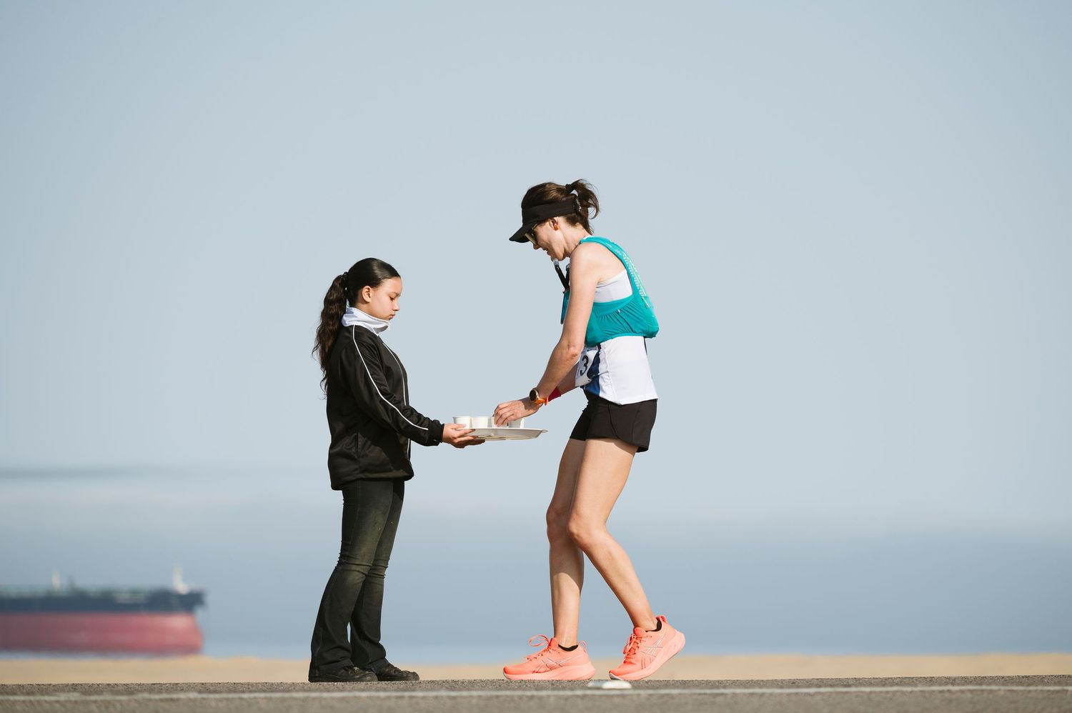 Runner taking water