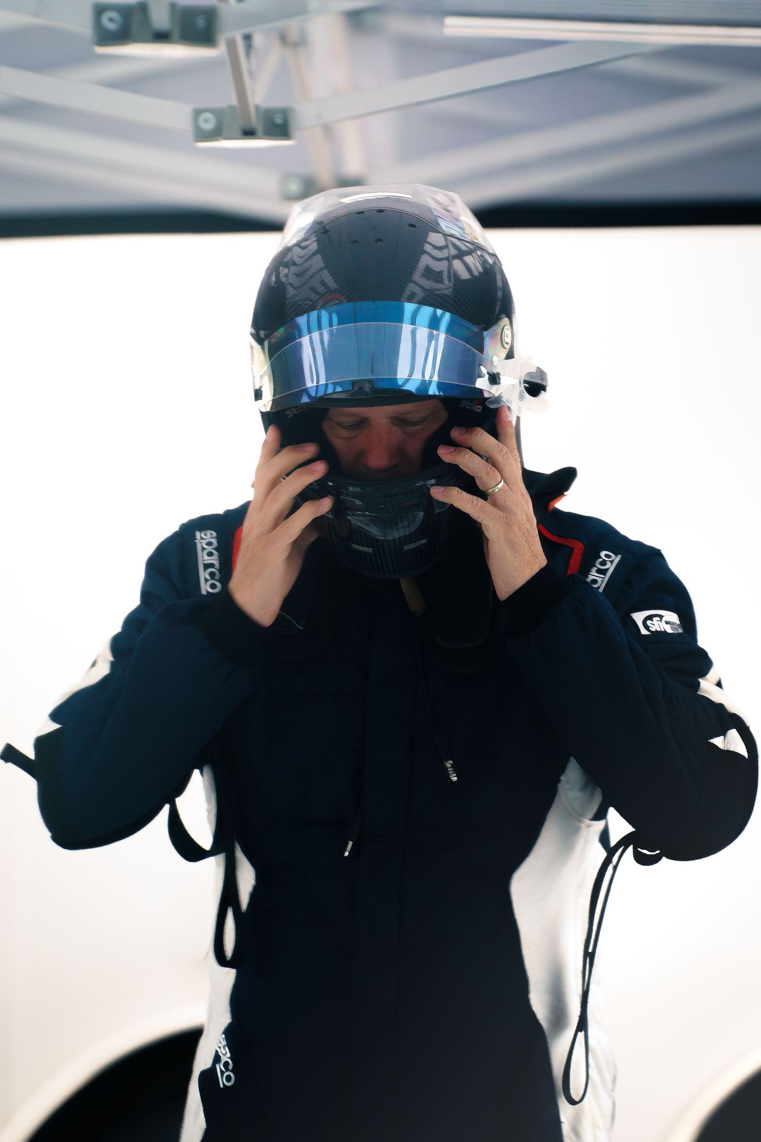 A person in a black jacket puts on a virtual reality headset in a sequence of photos showing the process.