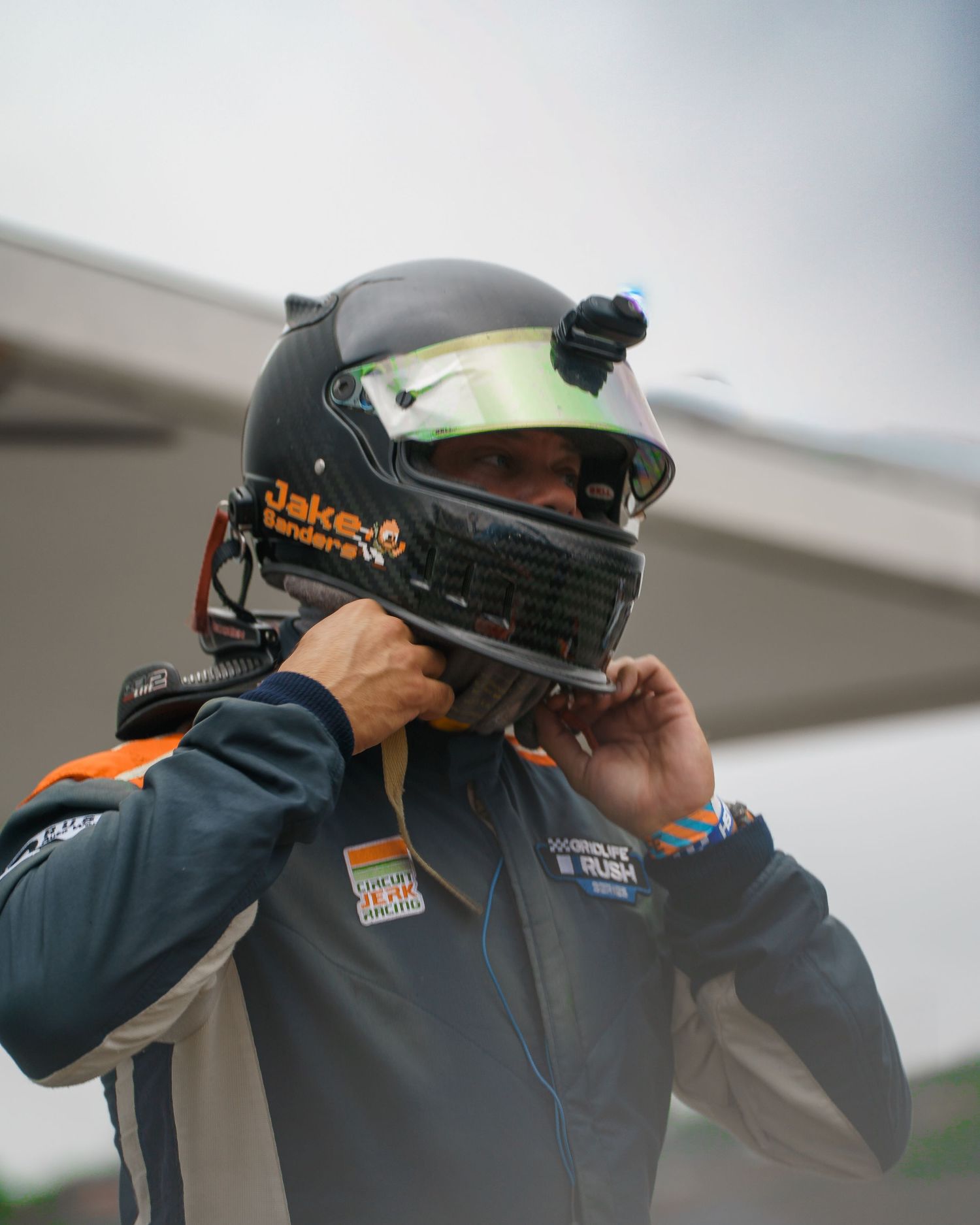 A sequence of photos showing someone putting on and adjusting a racing helmet before competition.