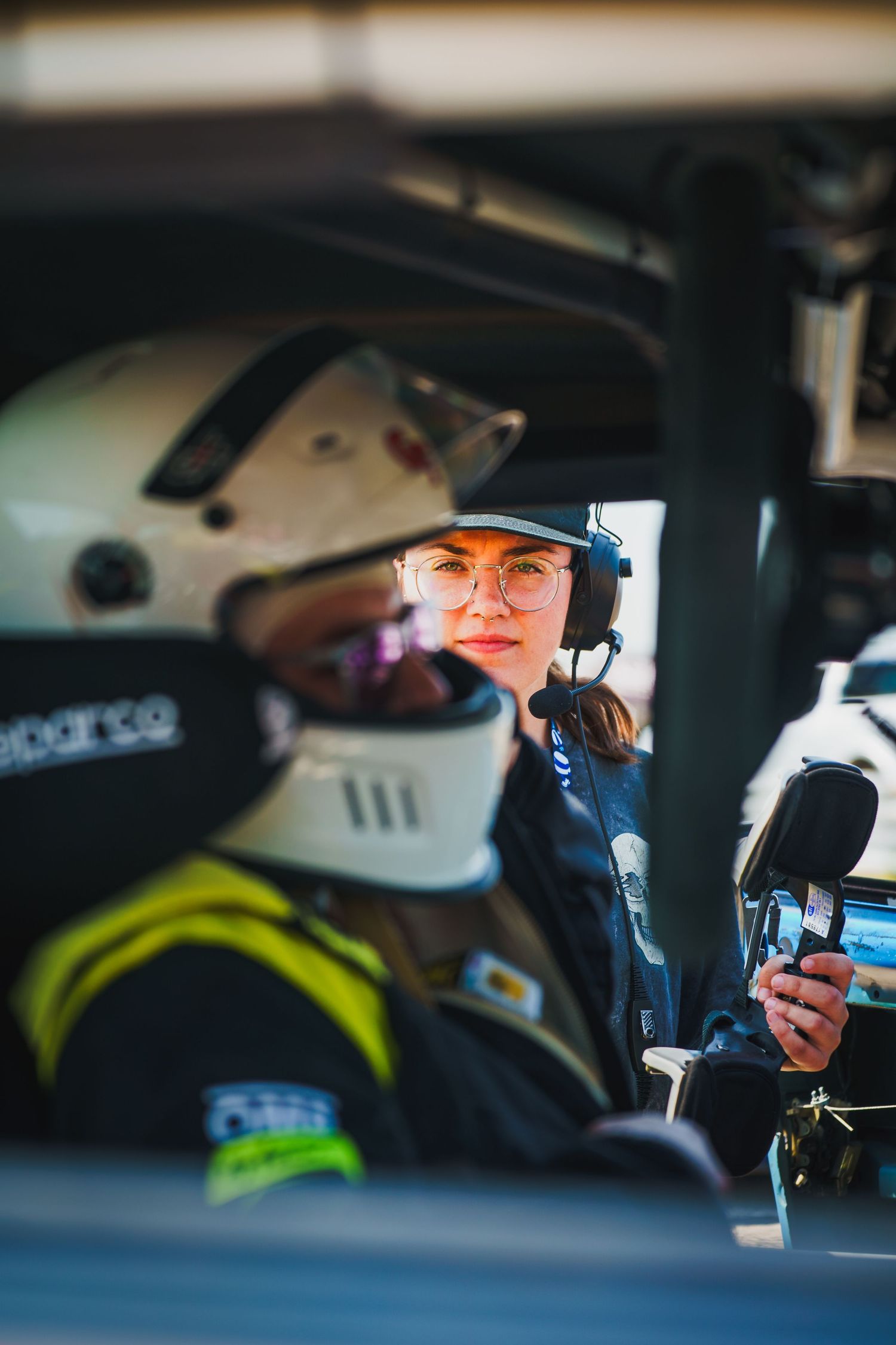 Police officers communicate via radio while sitting in patrol vehicles during law enforcement operations.