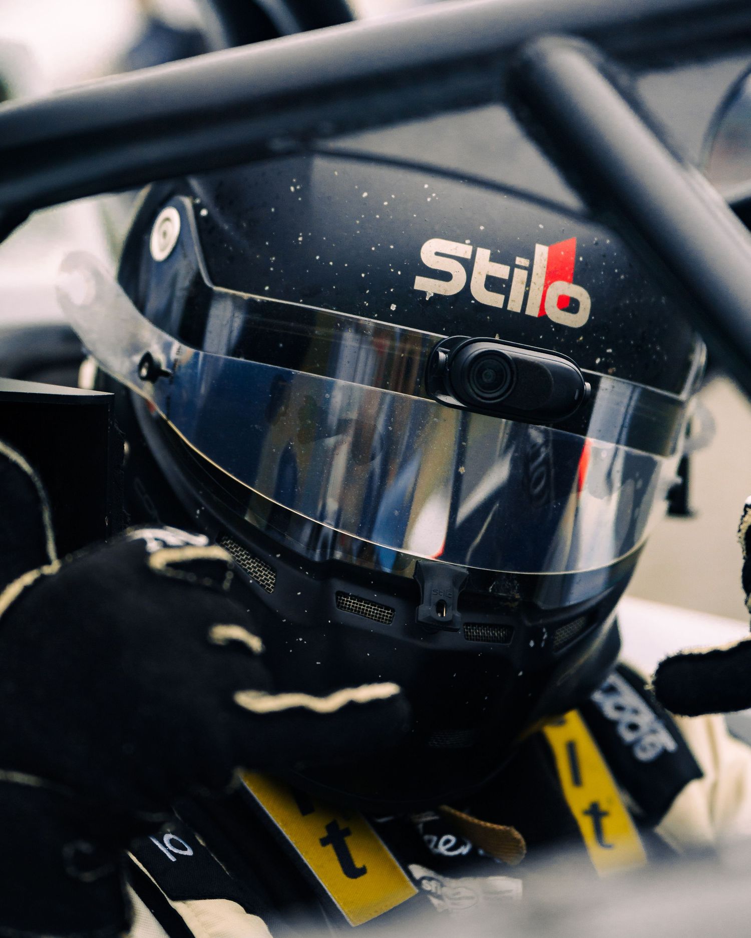 Close-up sequence of black racing helmet details showing visor and ventilation features in multiple angles.