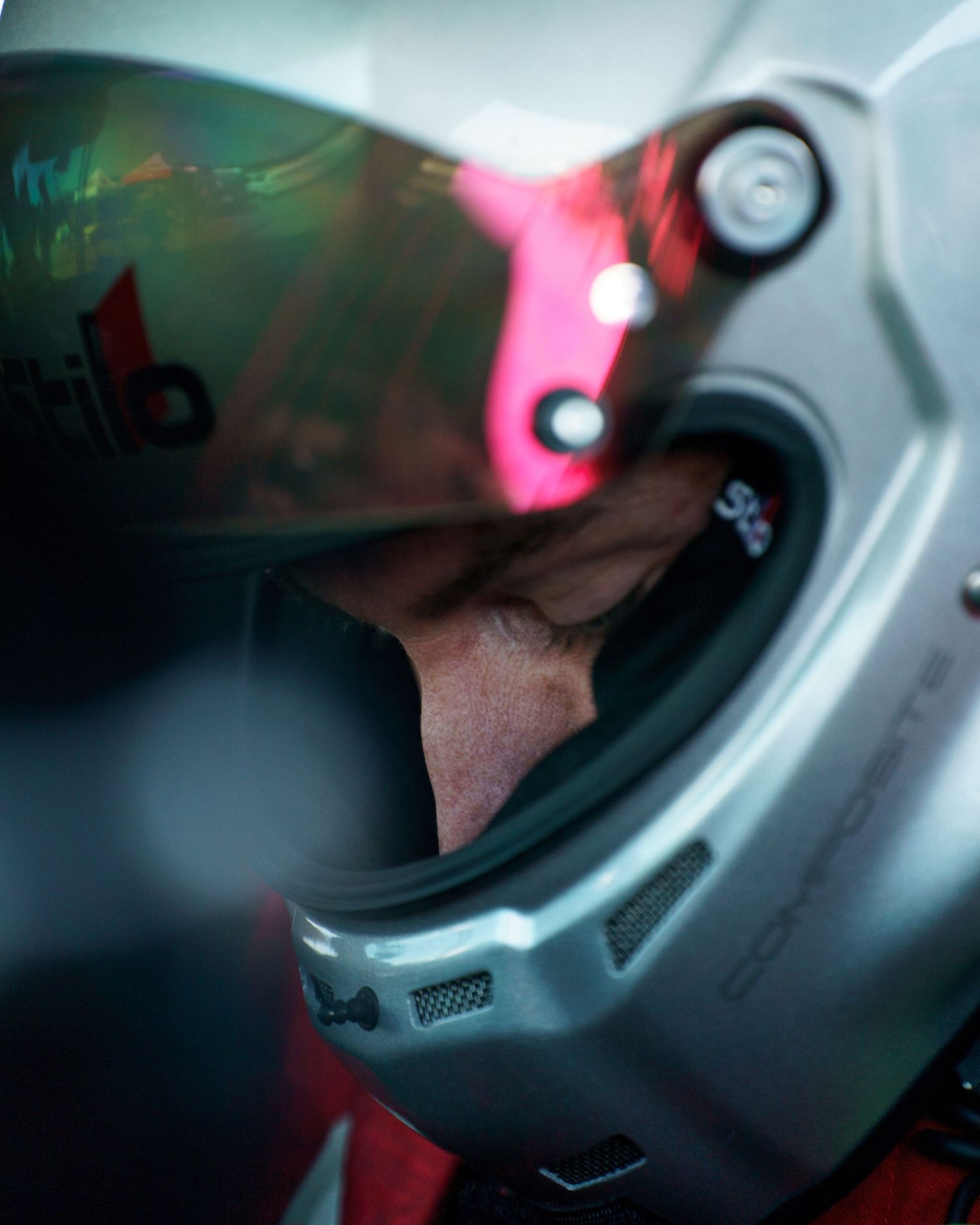 Close-up macro shots of a motorcycle helmet visor showing reflective surfaces and lighting effects.