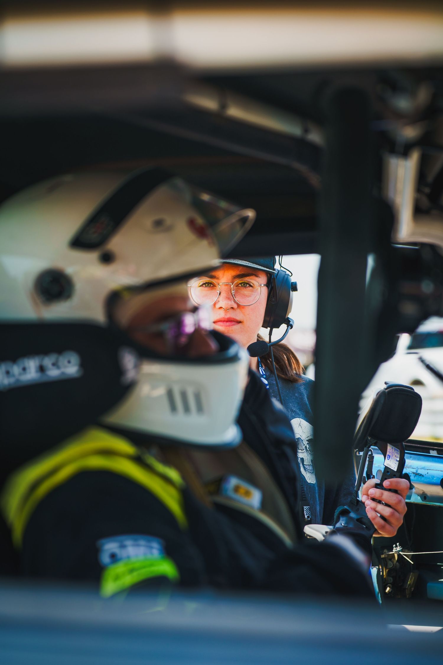 A close-up series of police officers sitting in patrol cars working on mobile devices and computers.