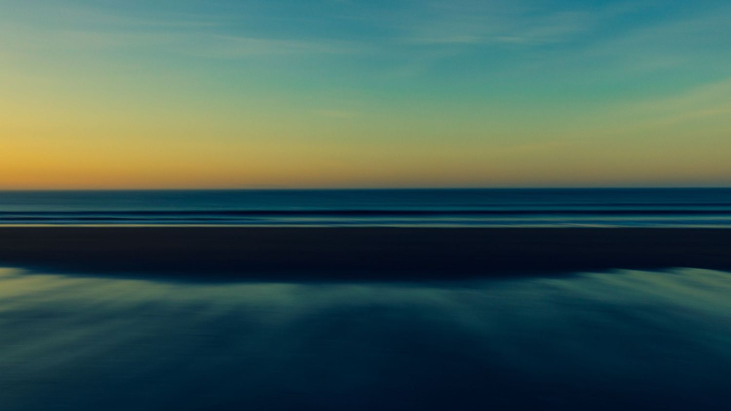 Abstract seascape at sunset with smooth gradient sky in orange and blue tones over calm dark ocean waters.