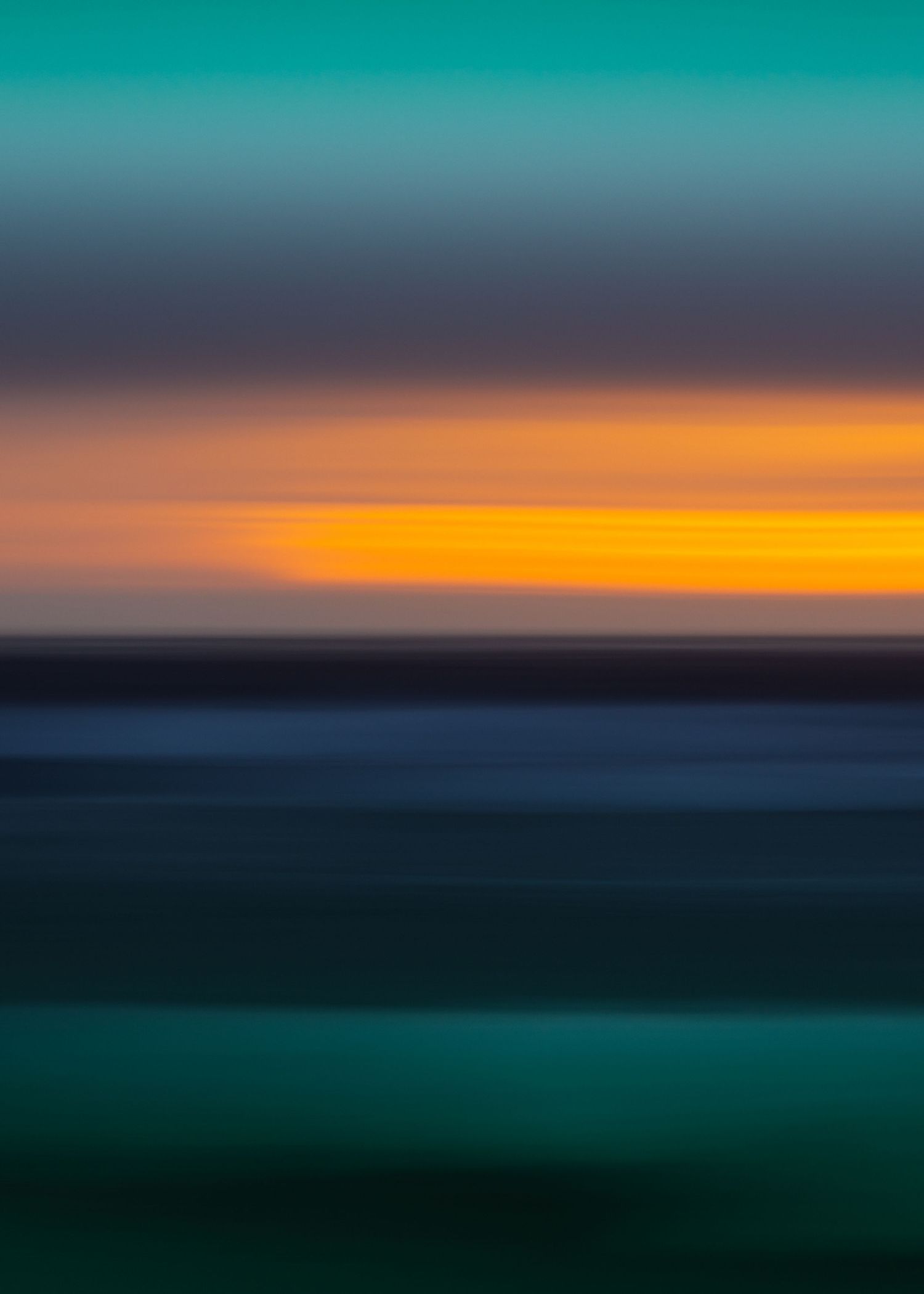Abstract motion blur seascape with vibrant teal, orange, and blue horizontal color bands at sunset.