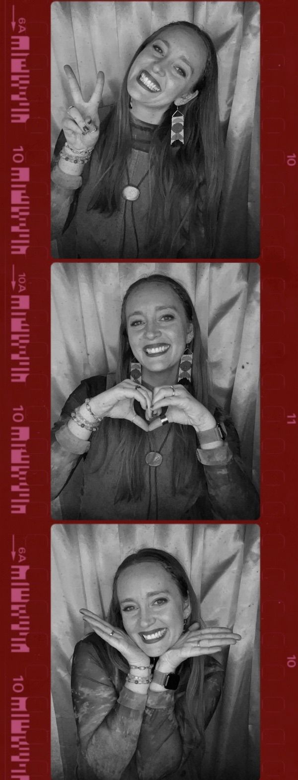 Black and white photo booth strip of smiling woman making peace and heart signs.