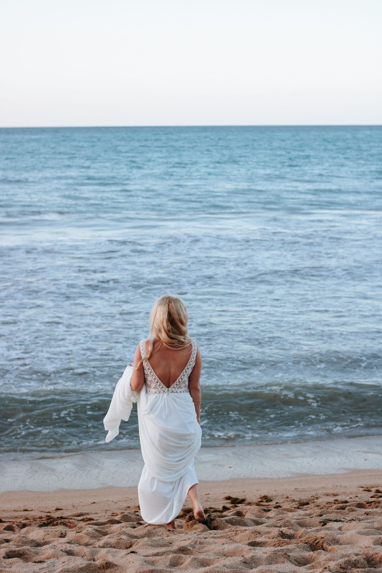 Bride on the beach walking