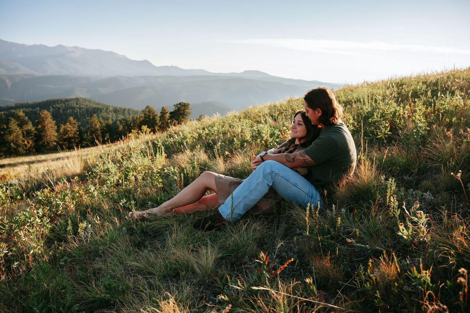 Couple sitting in a field with beautiful views
