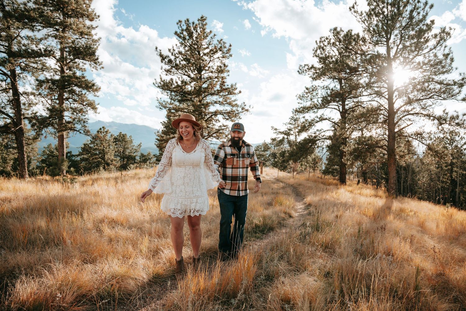 Engagement couple in Colorado mountains smiling